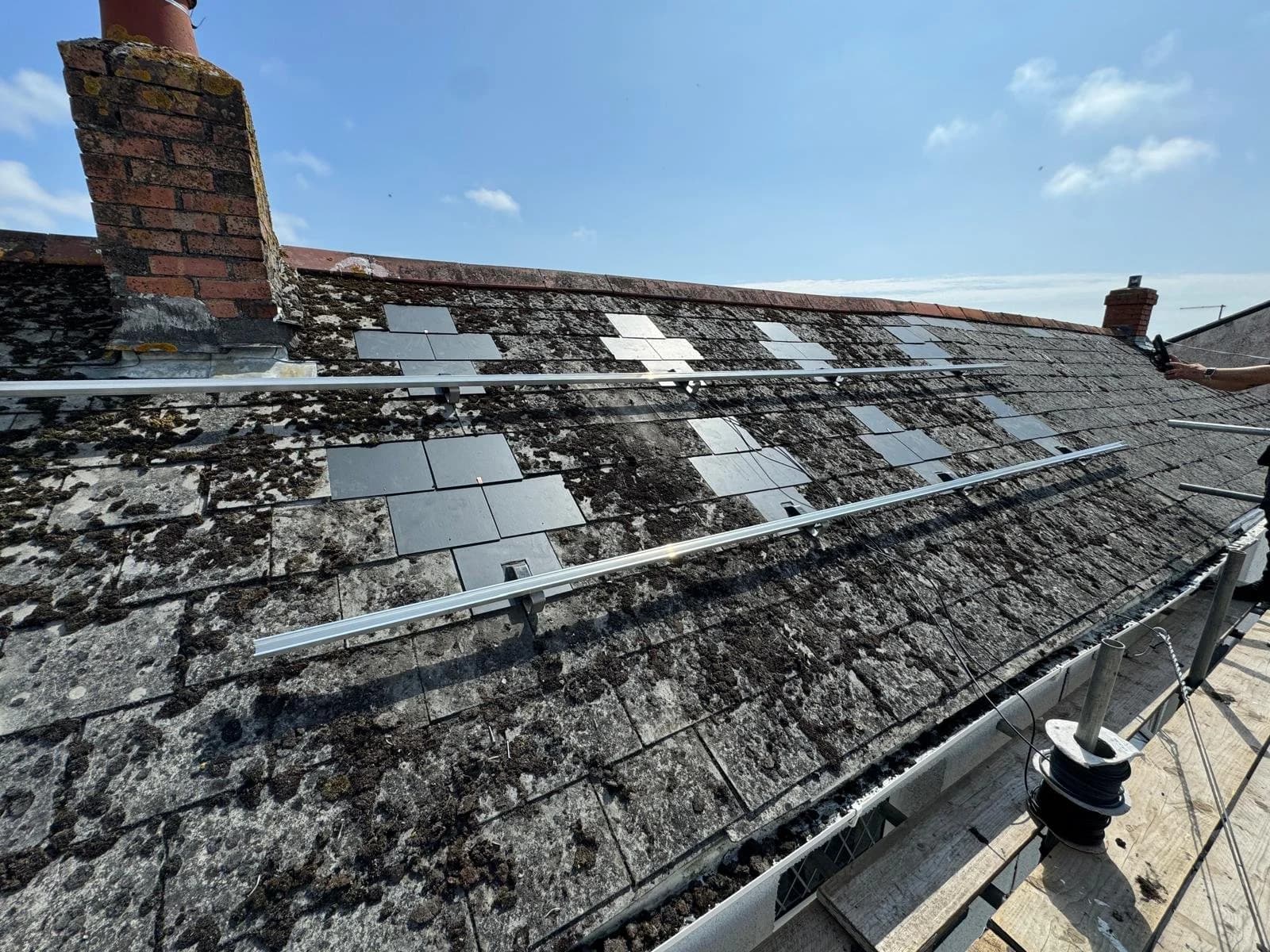 Mounting rails fixed to the slate roof before the panels were fitted
