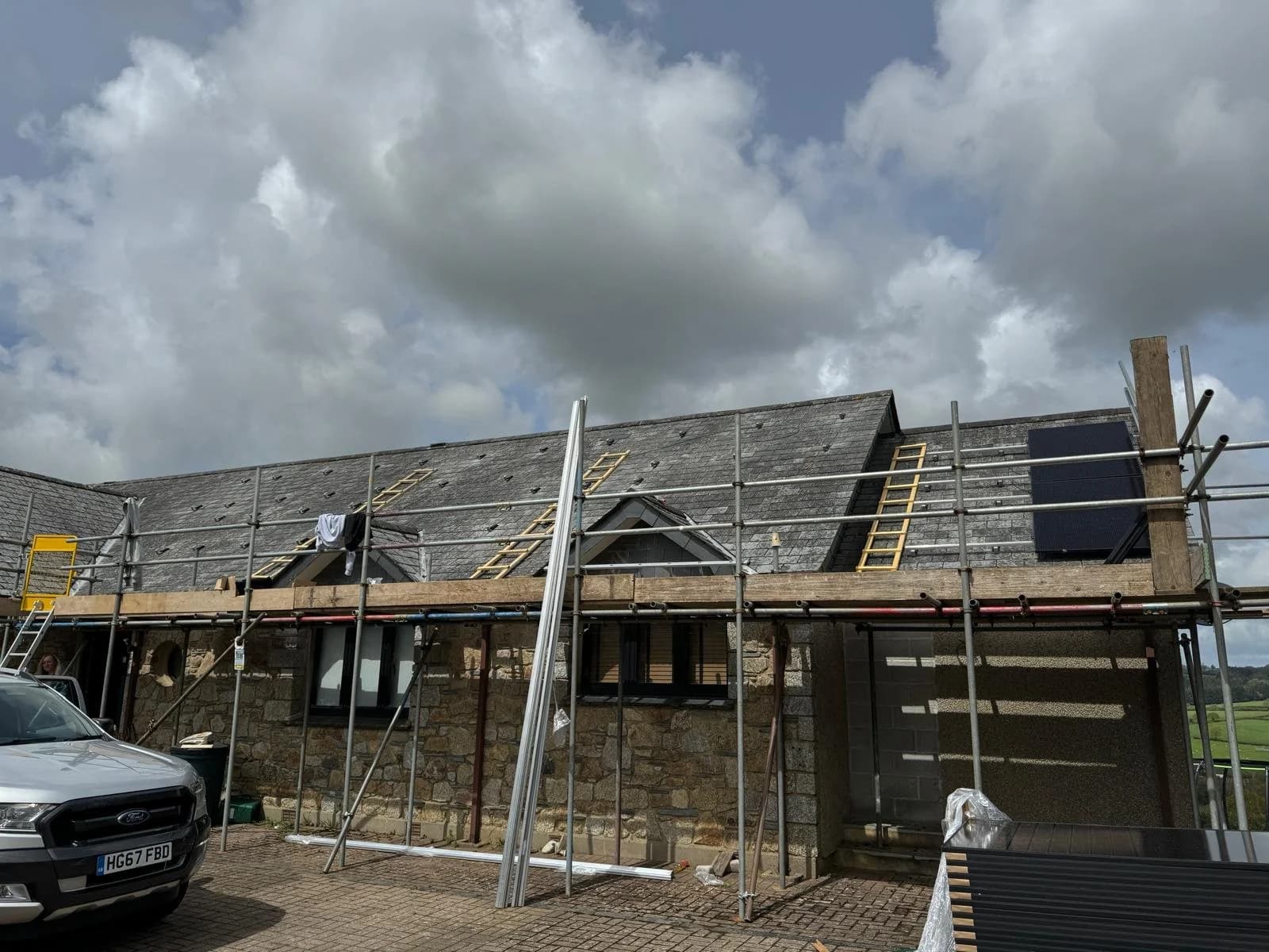 Scaffolding along the stone farmhouse at Dolcoath while the panels went on