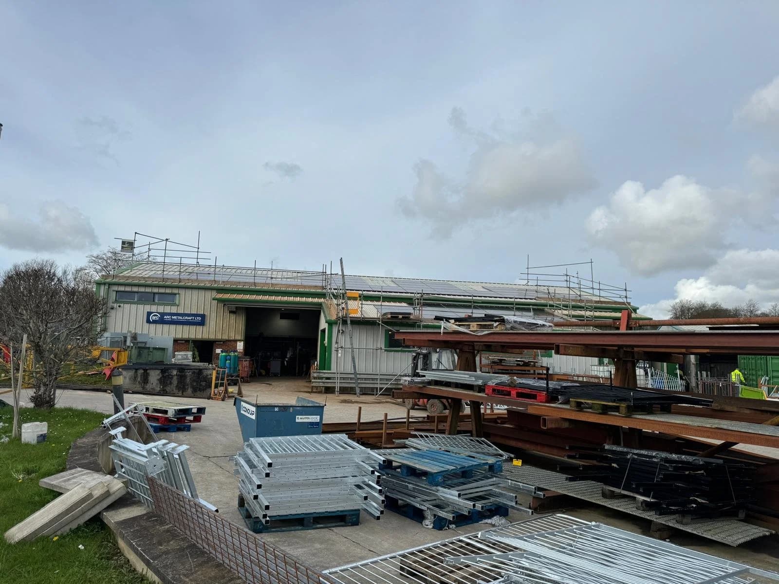 The Arc Metalcraft yard with steel beams in front of the workshop during the solar installation