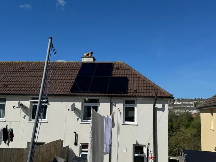 A solar panel installation on an end-terraced house roof