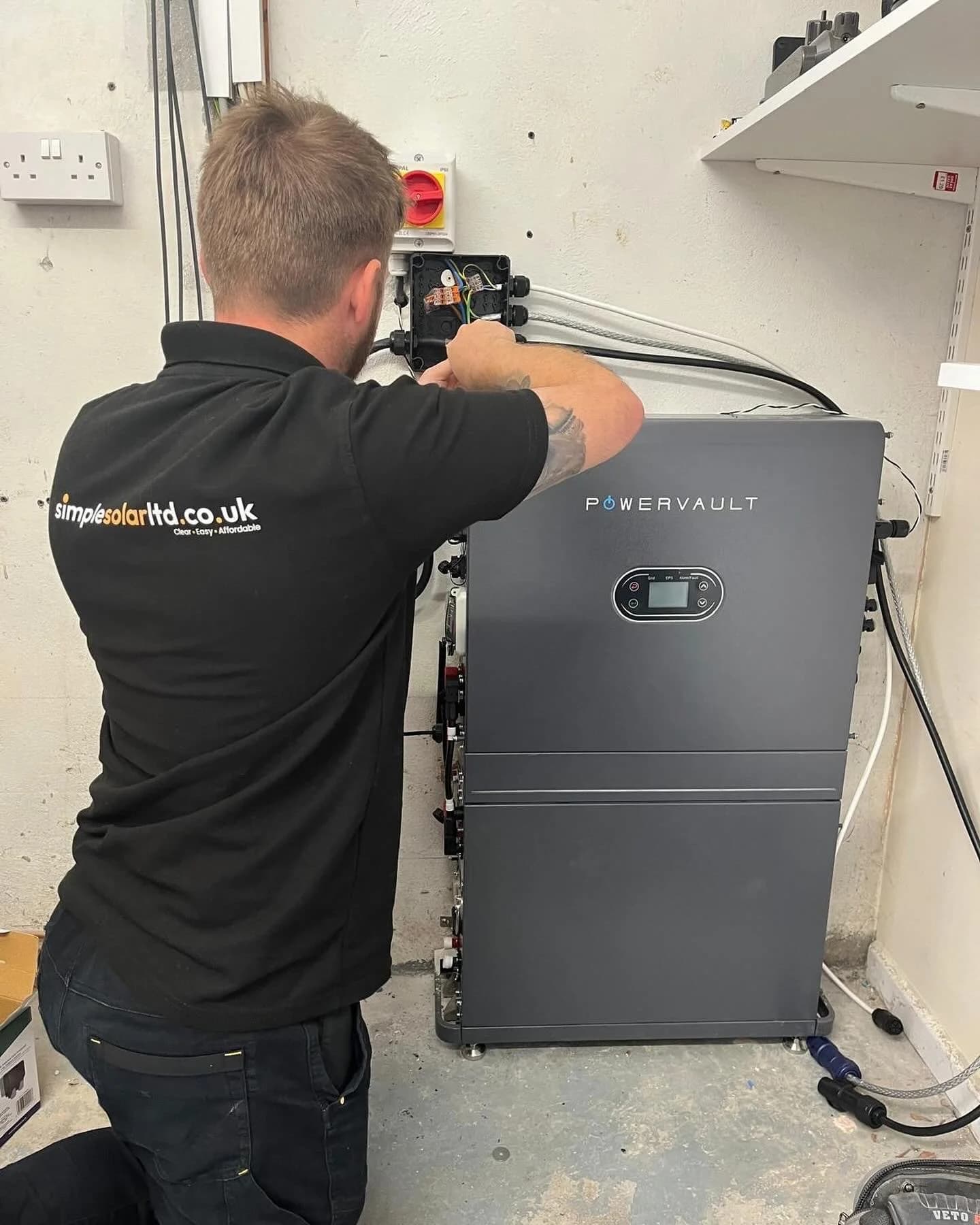 A Simple Solar installer wiring the Powervault home battery